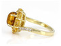 side view of amber citrine and zircon halo bypass ring in 18k yellow gold over sterling silver