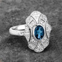 london blue topaz and white topaz vintage inspired ring in rhodium over sterling silver shown in a lifestyle photo