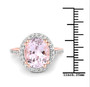 kunzite and white topaz oval halo ring in 18k rose gold over sterling silver shown for size comparison