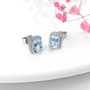 full view of aquamarine and white zircon halo earrings in rhodium over sterling silver
