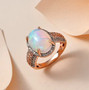 ethiopian opal pink and white diamond halo ring in solid 10k rose gold shown in a lifestyle photo