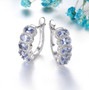 tanzanite and zircon hoop earrings in rhodium over sterling silver shown in a lifestyle photo