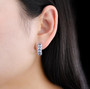 tanzanite and zircon hoop earrings in rhodium over sterling silver worn on the ear