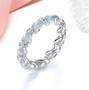 aquamarine and zircon eternity band ring in rhodium over sterling silver shown in a lifestyle photo