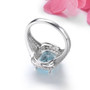 back view of sky blue topaz and white zircon halo ring in rhodium over sterling silver