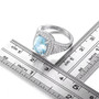 sky blue topaz and white zircon halo ring in rhodium over sterling silver shown for size comparison