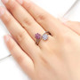 tanzanite and rhodolite garnet bypass cluster ring in rhodium over sterling silver worn on a hand