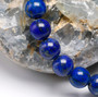 round natural lapis lazuli beaded stretch bracelet 6 8 or 10mm shown in a lifestyle photo