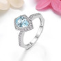 pear sky blue topaz and white zircon halo ring in rhodium over sterling silver shown in a lifestyle photo
