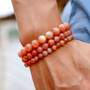 round natural peach moonstone beaded stretch bracelet 6 8 or 10mm worn on a wrist
