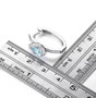 pear blue topaz and white zircon halo hoop earrings in rhodium over sterling silver shown for size comparison