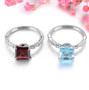 close up of garnet and white zircon ring in rhodium over sterling silver