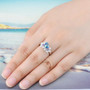blue topaz amethyst and zircon flower ring in rhodium over sterling silver worn on a hand