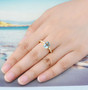 sky blue topaz and white zircon ring in 18k yellow gold over sterling silver worn on a hand