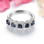 front view of blue sapphire and white zircon halo band ring in rhodium over sterling silver