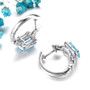 back view of sky blue topaz and white zircon hoop earrings in rhodium over sterling silver