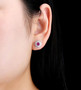 ruby and white zircon stud earrings in rhodium over sterling silver worn on the ear
