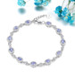 tanzanite and white zircon halo adjustable bracelet in rhodium over sterling silver shown in a lifestyle photo