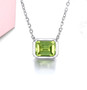 bezel set emerald cut peridot necklace in rhodium over sterling silver shown in a lifestyle photo