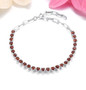 round garnet adjustable paperclip bracelet in rhodium over sterling silver shown in a lifestyle photo