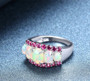 close up of ethiopian opal and rhodolite garnet ring in rhodium over sterling silver