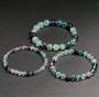 round natural multi color fluorite beaded stretch bracelet 6 8 or 10mm shown in a lifestyle photo