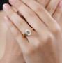 petalite and white topaz ring in 18k yellow gold over sterling silver worn on a hand