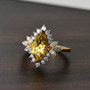 marqise heliodor and moissanite halo ring in 18k yellow gold over sterling silver shown in a lifestyle photo