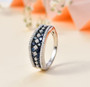ceylon blue sapphire and moissanite band ring in rhodium over sterling silver shown in a lifestyle photo