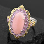 pink opal and sapphire halo ring in 18k yellow gold and rhodium over sterling silver shown in a lifestyle photo