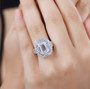 petalite tanzanite and white topaz double halo ring in rhodium over sterling silver worn on a hand
