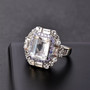 petalite tanzanite and white topaz double halo ring in rhodium over sterling silver shown in a lifestyle photo