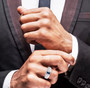 blue and white moissanite gents ring in rhodium over sterling silver worn on a hand
