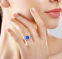 blue spinel and white zircon halo ring in rhodium over sterling silver worn on a hand