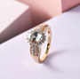alexandrite and white diamond halo ring in solid 18k yellow gold shown in a lifestyle photo