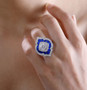 moissanite and green enamel ring in rhodium over sterling silver worn on a hand