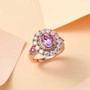 kunzite pink sapphire and moissanite halo ring in 18k rose gold over sterling silver shown in a lifestyle photo