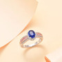 ceylon blue and pink sapphire and white zircon ring in 18k rose gold and rhodium over sterling silver shown in a lifestyle photo