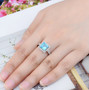square cut swiss blue topaz halo ring in rhodium over sterling silver