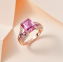pink and white moissanite and pink sapphire bridge ring in 18k rose gold over sterling silver shown in a lifestyle photo