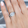 moissanite and green sapphire ring in rhodium over sterling silver worn on a hand