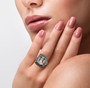 prasiolite and brown zircon halo ring in rhodium over sterling silver worn on a hand