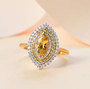 heliodor yellow sapphire and moissanite marquise halo ring in 18k yellow gold over sterling silver shown in a lifestyle photo