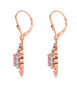 side view of pink spinel and white zircon dangle earrings in 18k rose gold over sterling silver
