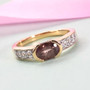 color change garnet and zircon band ring in 18k yellow gold over sterling silver shown in a lifestyle photo