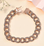 champagne diamond curb link bracelet in 18k rose gold over sterling silver shown in a lifestyle photo