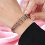 champagne diamond curb link bracelet in 18k rose gold over sterling silver worn on a wrist