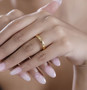 4mm 18k yellow gold over sterling silver band ring worn on a hand
