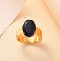 oval black jade solitaire ring in 18k yellow gold over sterling silver shown in a lifestyle photo