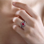 ruby (ff) and white zircon double halo ring in rhodium over sterling silver worn on a hand